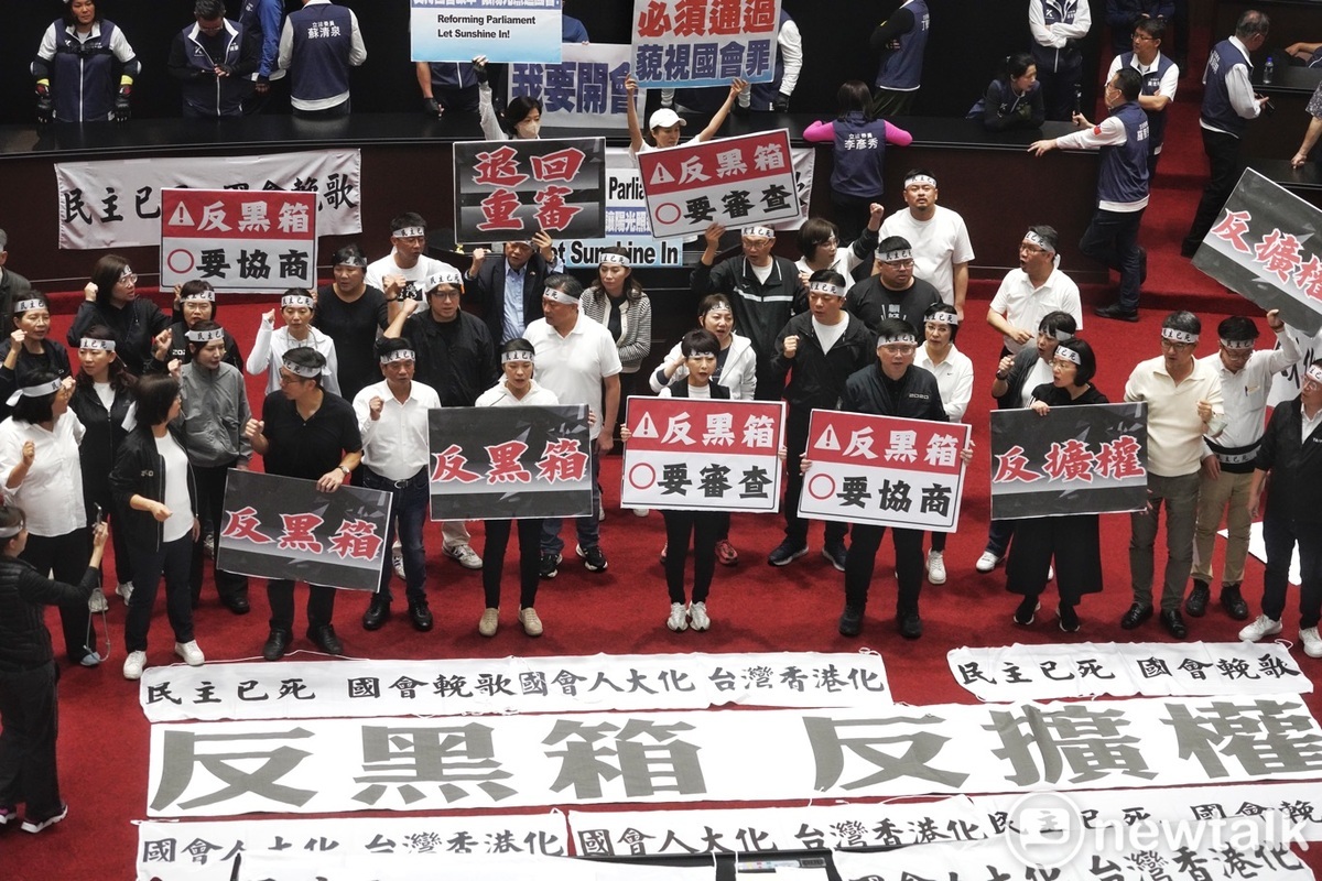 立法院今續審國會擴權等法案，朝野立委各自在主席台及議場前方集結，呼喊抗議口號，由於議事無法進行，主席韓國瑜宣布休息進行朝野協商。 圖：張良一/攝