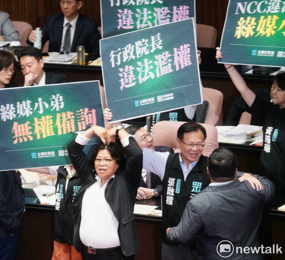 立法院新會期今開議，民眾黨立委在行政院長卓榮泰面前舉牌杯葛議事，民進黨立委王美惠則是手比愛心反制。 圖：張良一 / 攝
