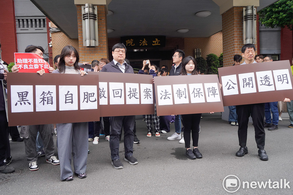 針對國民黨立委陳玉珍提案修修法「助理費除罪化」，立委院國會助理在立院大門口拉開白布條並高舉手舉牌呼喊口號，要求陳玉珍撤案。圖為民眾黨立委張啟楷前往現場致意。 圖：張良一/攝