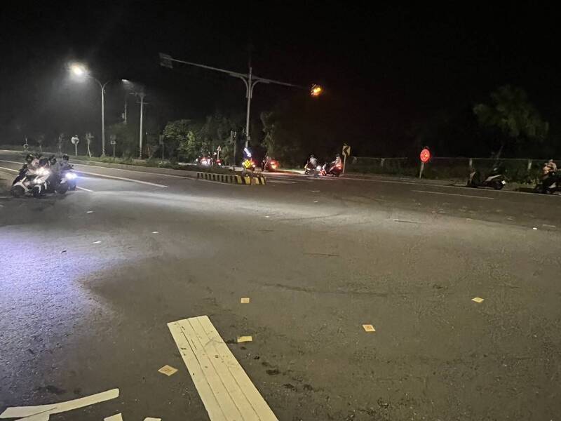 林姓男子深夜帶兄長遺照站路邊，撒冥紙稱提醒減緩車速。 圖：民眾提供