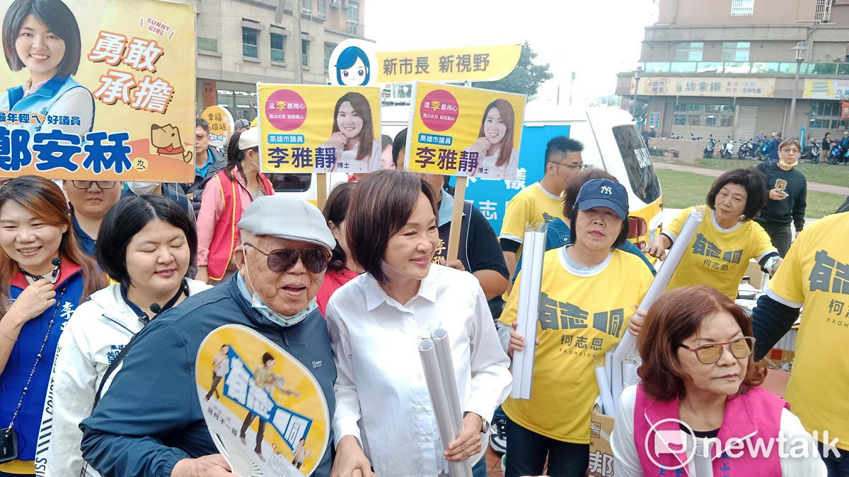 柯志恩(前排左二)在鳳山工協街廣場發放年曆。 圖：孫家銘/攝