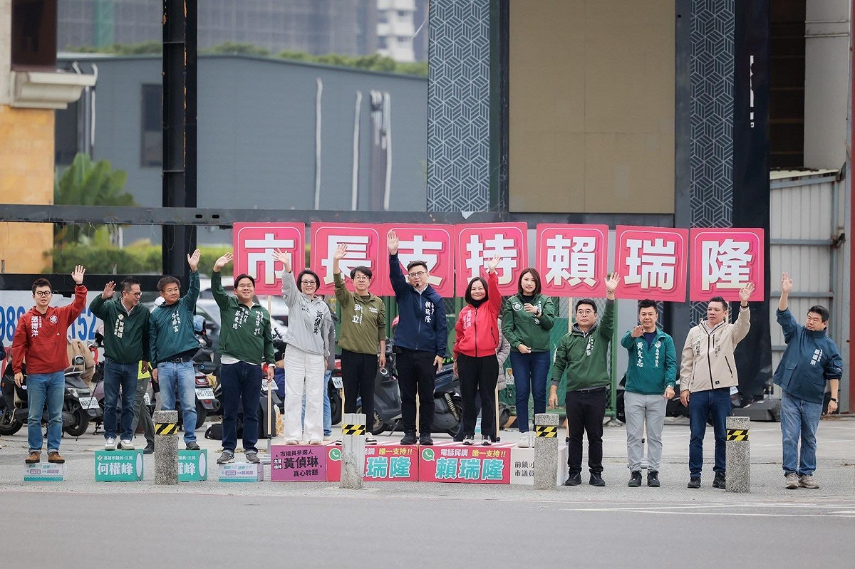 賴瑞隆(中)日在多位市議員及參選人陪同下，站路口向通勤族問早致意。 圖：賴瑞隆辦公室/提供