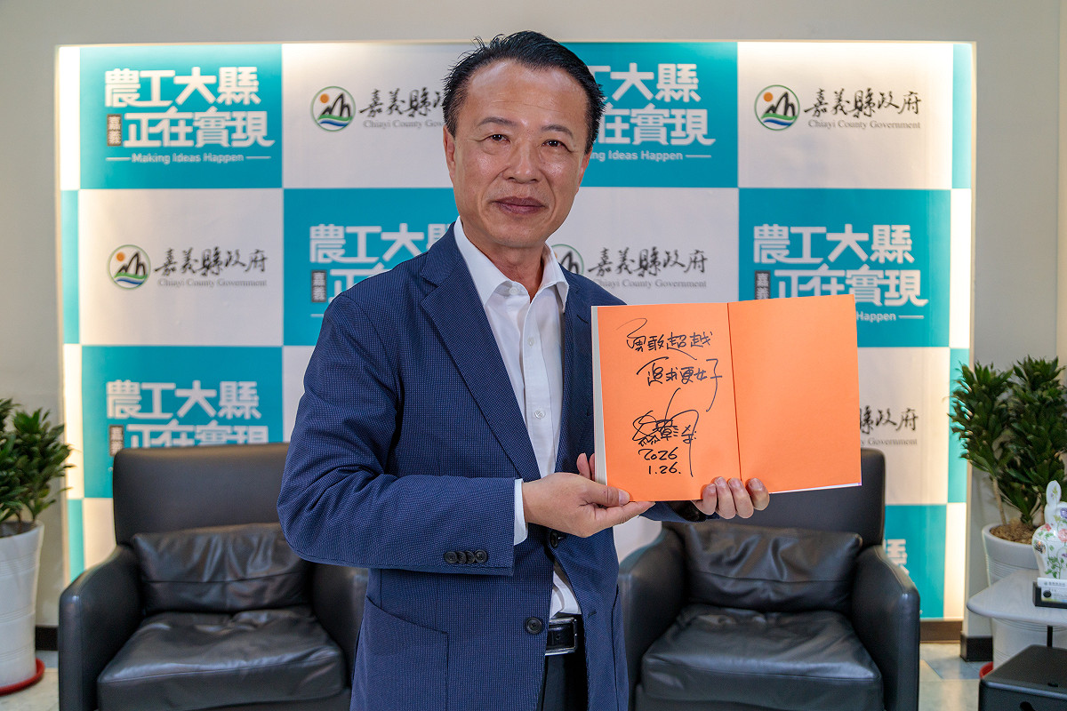 嘉義縣長翁章梁28日響應紙風車「椅子會」小額捐款行動，特別捐出親筆簽名的「青年的四個大夢」100本贈送給捐款人。 圖：嘉義縣政府提供