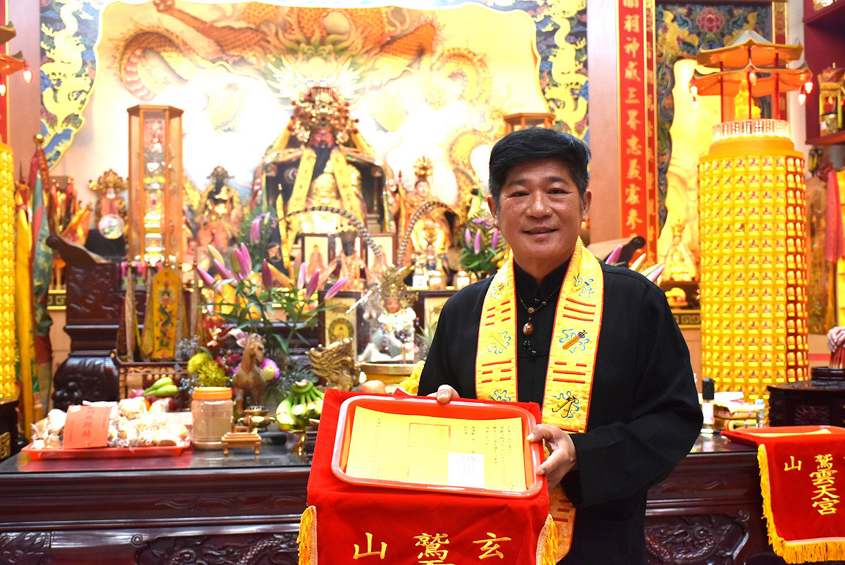 高雄市鳥松區玄鷲山高邑雲天宮主持曾俊豐，手捧關聖帝君抽出的丙午年「國運籤」。 圖：孫家銘攝（資料照）