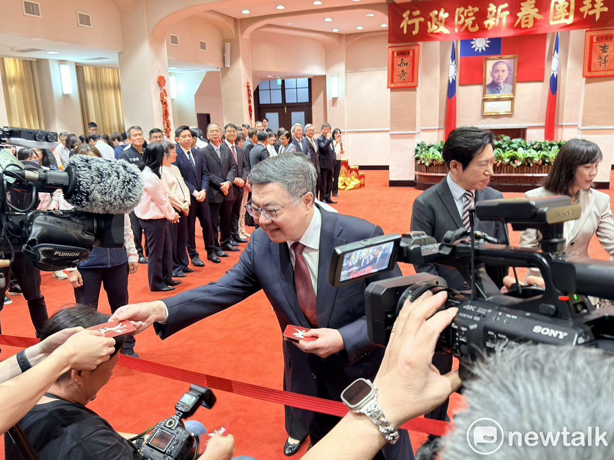 行政院長卓榮泰今（23）日新春團拜致詞後，驅前和在場的媒體記者握手並發送馬年福袋。 圖：謝莉慧/攝