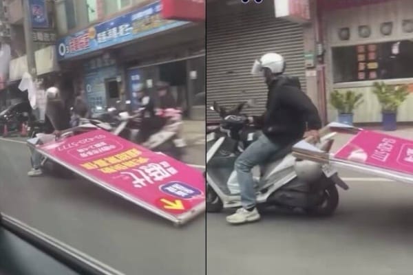 中壢機車騎士單手騎車，拖行巨大廣告看板。 圖：翻攝自WoWtchout – 地圖型行車影像分享平台