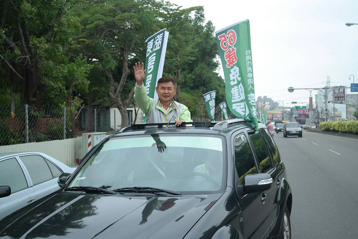台南市長參選人李俊毅在永康區及北區進行車隊遊行宣傳，許多人看到電視牆宣傳車紛紛跑出來觀看。 圖：黃博郎／攝