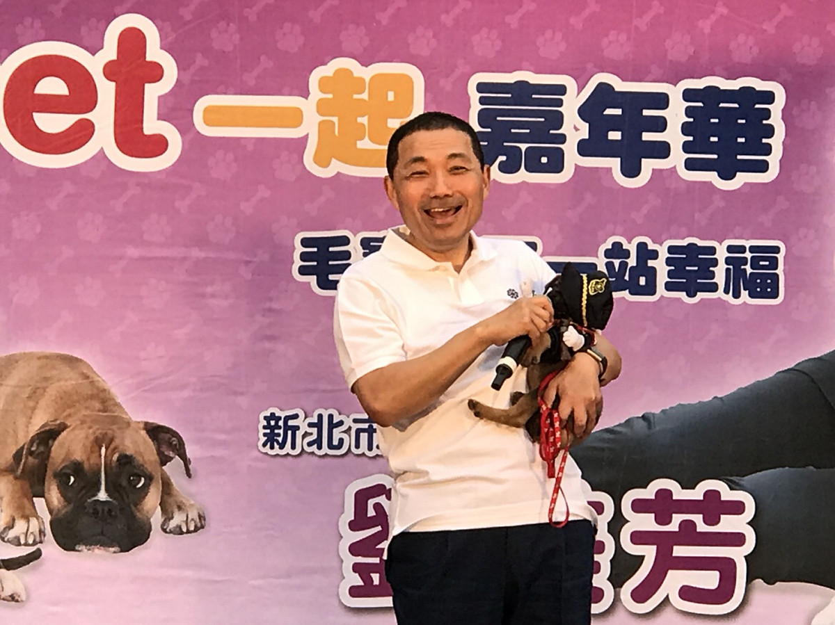 侯友宜與穿警察制服、戴警帽的毛小孩逗趣互動，台上台下同樂。 圖：翻攝動保處