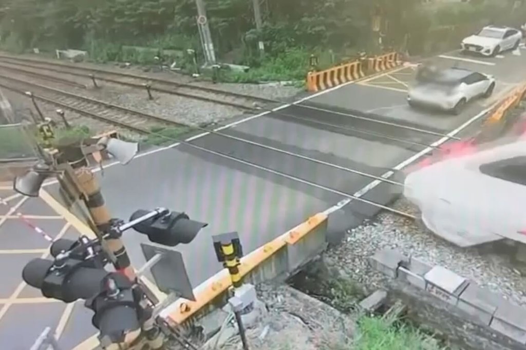 一輛自小客車26日下午行經桃園平鎮區新光平交道時停留於平交道內，待警鈴作響、遮斷桿放下後仍無法通過，現場民眾協助抬起遮斷桿，車輛隨即駛離；警方調閱平交道監視影像釐清案情，確認違規事實。（鐵路警察局提供）中央社記者吳睿騏桃園傳真　115年7月27日