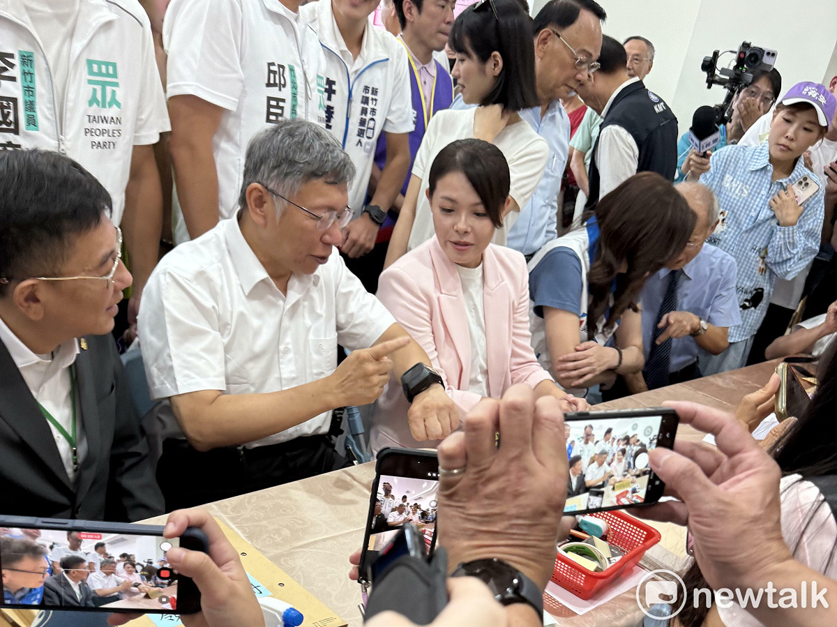 民眾黨創黨主席柯文哲跟新竹市長高虹安介紹手上的電子手環。 圖：周煊惠 / 攝