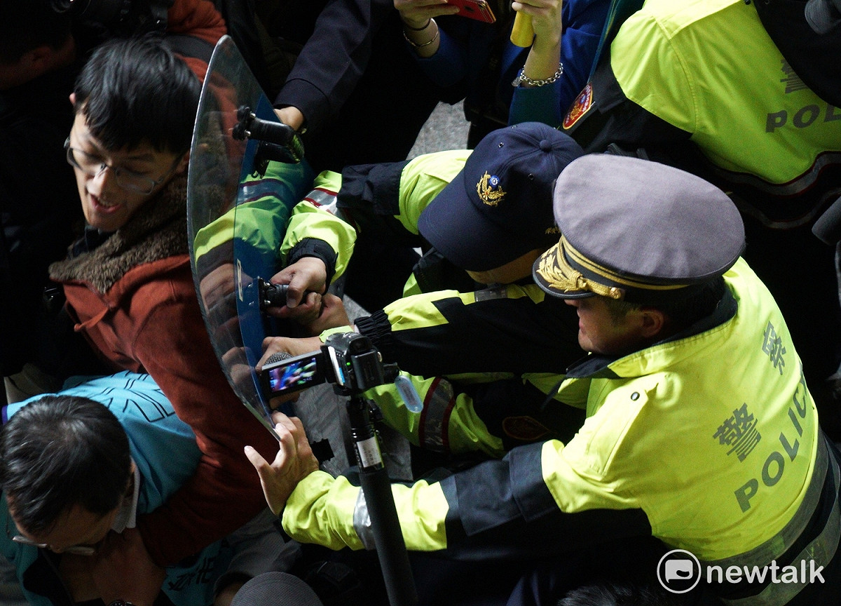 勞工團體與反對人士天號招數百人在立法院外高舉白布條示威抗議，現場爆發第二波衝突，雙方人馬發生推擠，警方試圖驅離抗議人士，但受到強烈反抗。 圖：張良一/攝