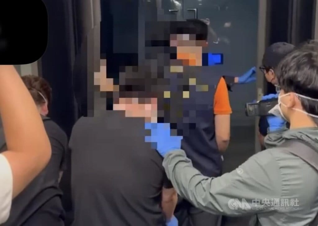 吳姓男子（前中）涉嫌在西門町某旅店內勒斃泰國籍女友，再把屍體裝入大型行李箱運送至台中工作地點的冰櫃內。台北市警方獲報循線逮捕吳男到案，訊後依殺人罪嫌送辦。（翻攝畫面）中央社記者劉建邦傳真　115年9月19日