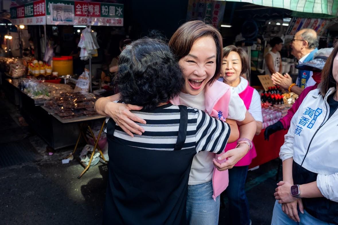 柯志恩(右)被婦女姊妹熱情「討抱抱」。 圖：柯志恩競辦／提供