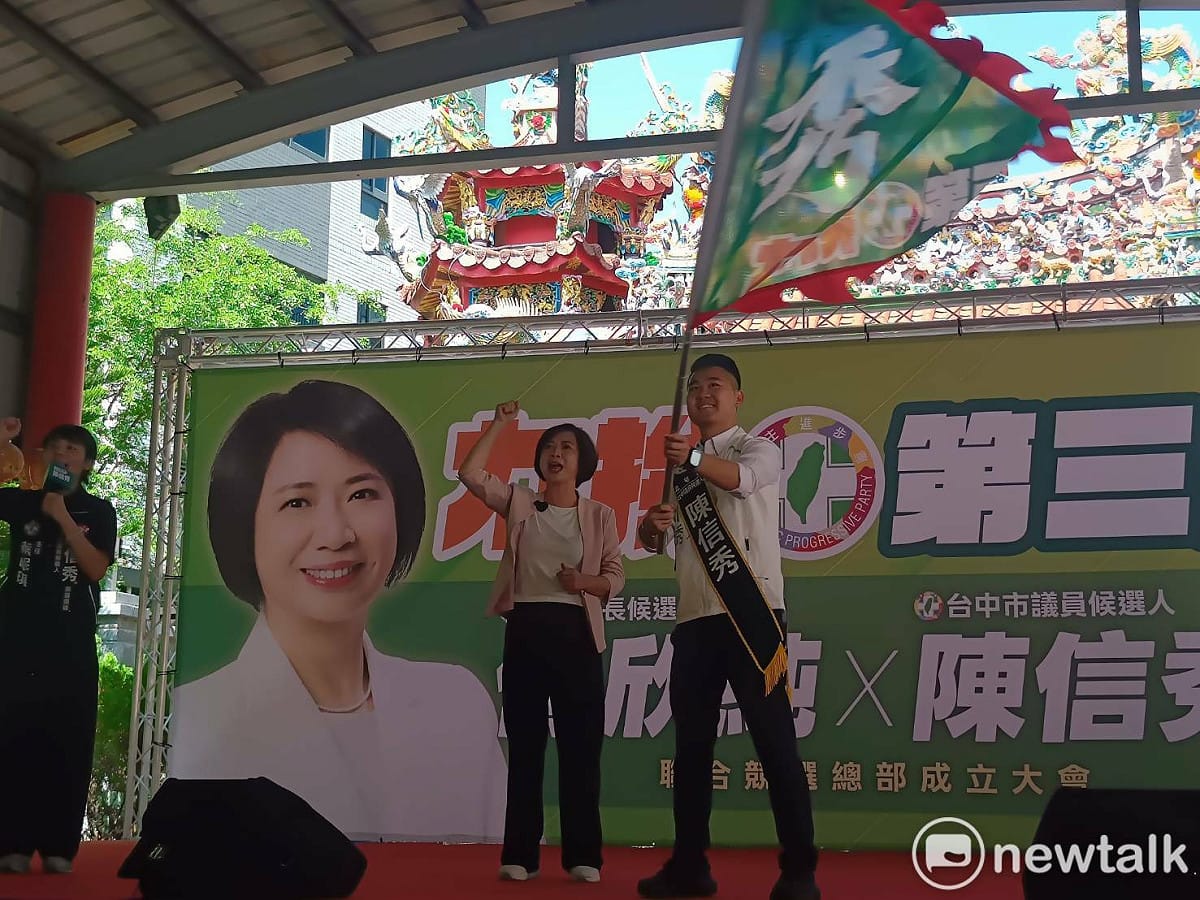 何欣純授戰旗給陳信秀。 圖：唐復年/攝