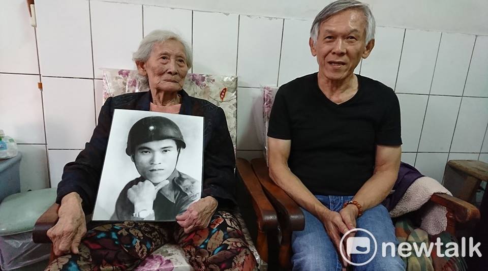 現年八十七歲的八二三烈士遺孀陳賴玉昭女士，手捧二十九歲的丈夫遺照，與長子陳耀東合影。 圖: 王瓊玲/攝