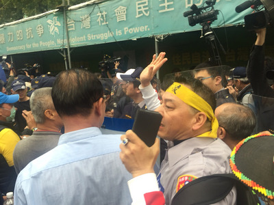 反軍人年改團體27日下午持續抗爭，拆除濟南路獨派團體帳篷上的旗幟並燒毀，打算拆第二面旗幟時，與警方爆發衝突。 圖 : 中央社