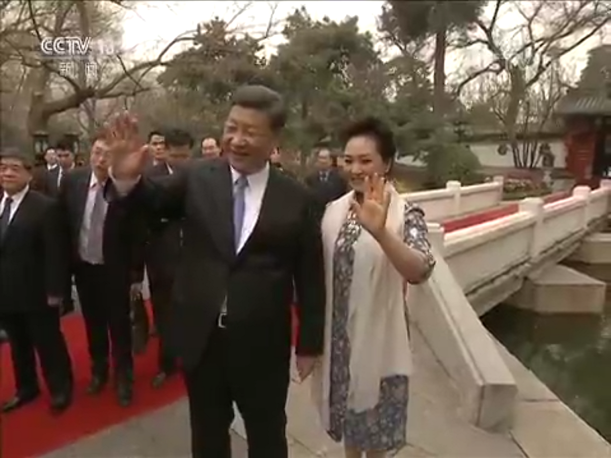 金正恩和夫人李雪主結束參觀行程驅車離去，習近平和夫人彭麗媛揮手道別。 圖：翻攝自央視畫面