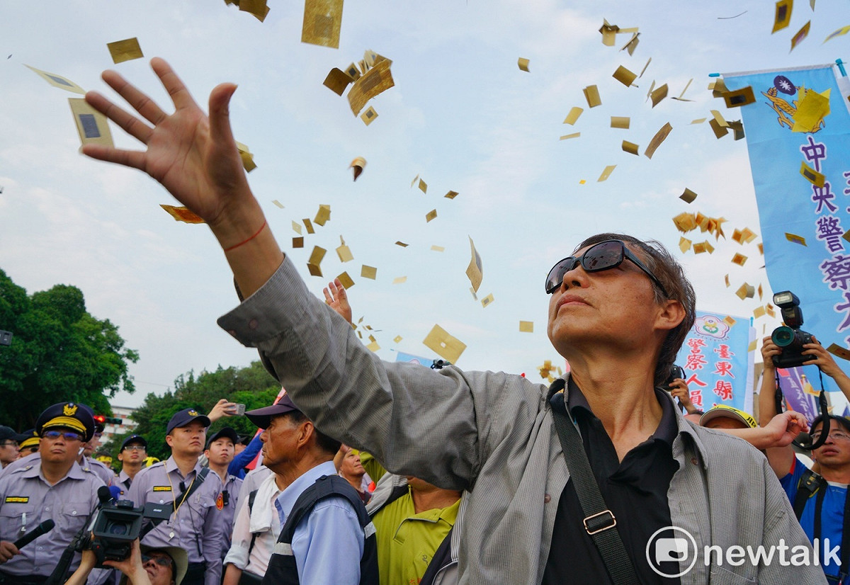 遊行抗議隊伍沿路呼喊訴求，沿路撒冥紙。 圖：張良一／攝