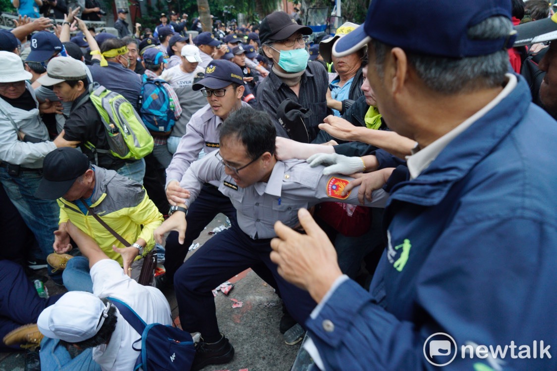該名警察掙脫反年改人士的包圍。 圖：張良一/攝