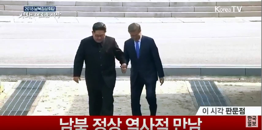 朝鮮領導人金正恩（左）緊握韓國總統文在寅的手，一起拾階而上，意顯示兩韓的兄弟情誼。 圖：翻攝Korea TV