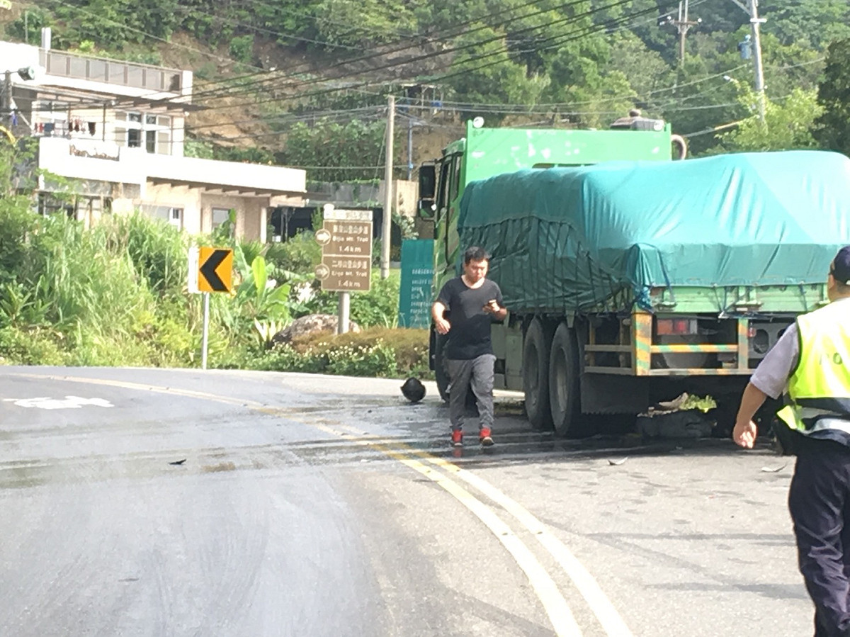 北宜公路驚傳砂石車車禍，一名重機騎士頭卡車輪下，當場沒有生命跡象。 圖/新北消防局提供
