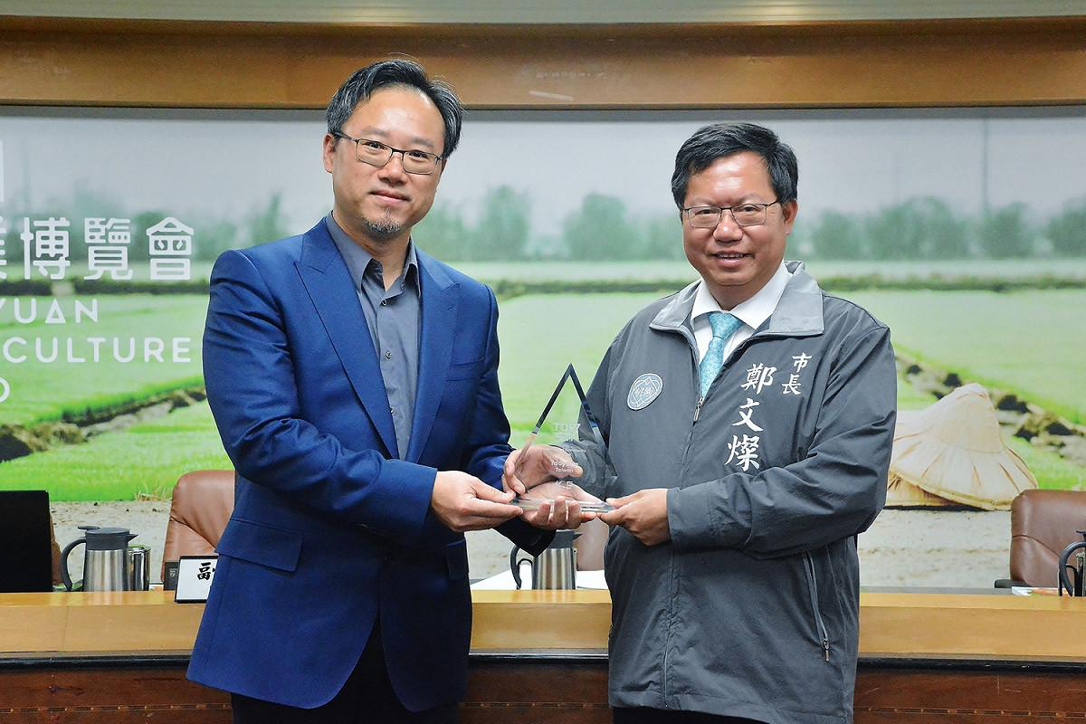 桃園市長鄭文燦在市政會議上，接受資訊科技局陳崗熒呈獻「2018全球7大智慧城市」槳座殊榮。 圖：桃園市政府/提供