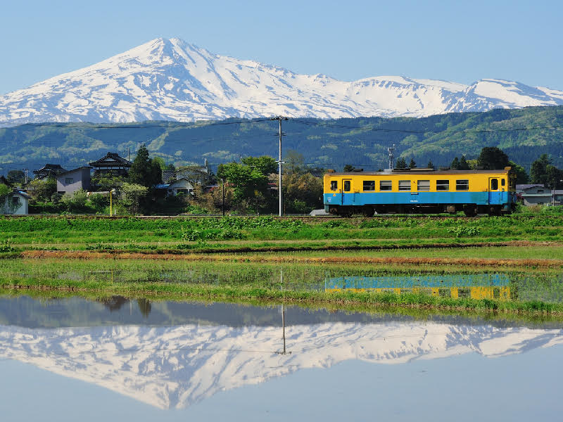 「由利高原鐵道」以秋田名山「鳥海山麓」為背景，行經的12個車站各具特色，這條鐵路被譽為是「大自然的觀光列車」。 圖：易遊網提供