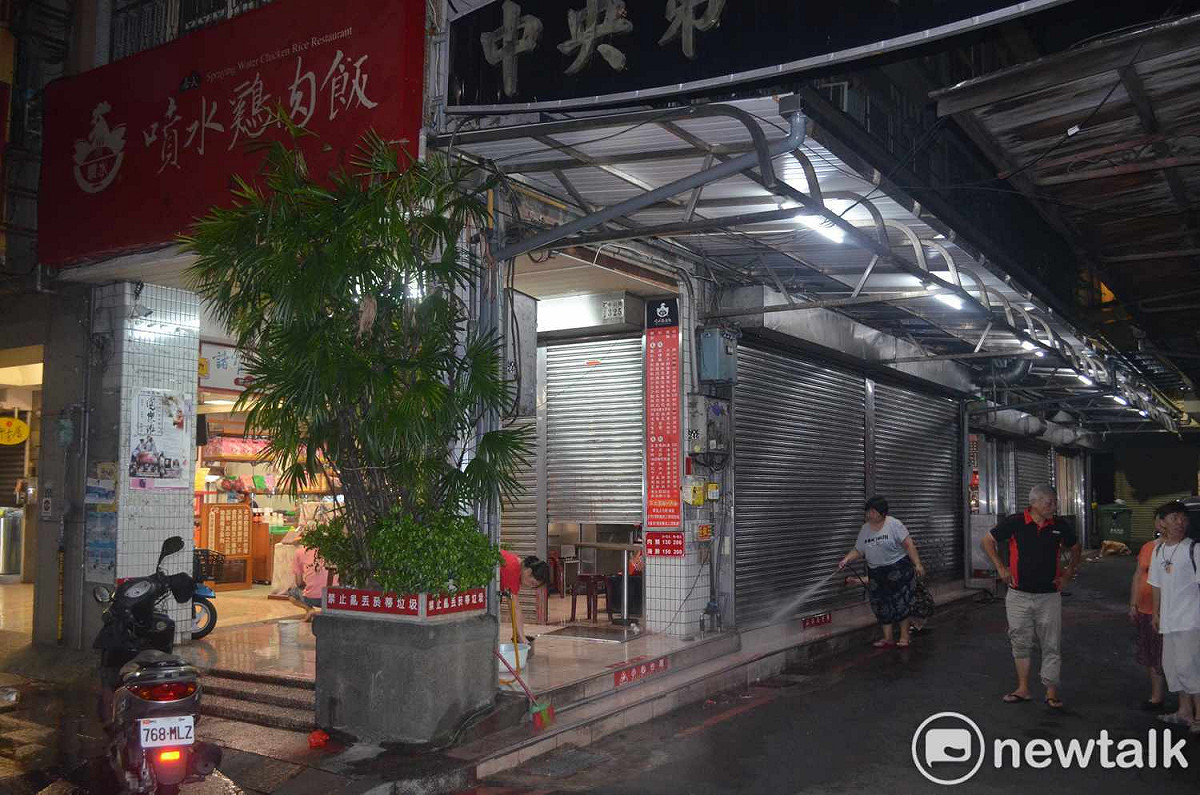 嘉義市知名噴水雞肉飯12日晚間遭人潑漆，員工忙著清洗現場。 圖：蔡坤龍/攝