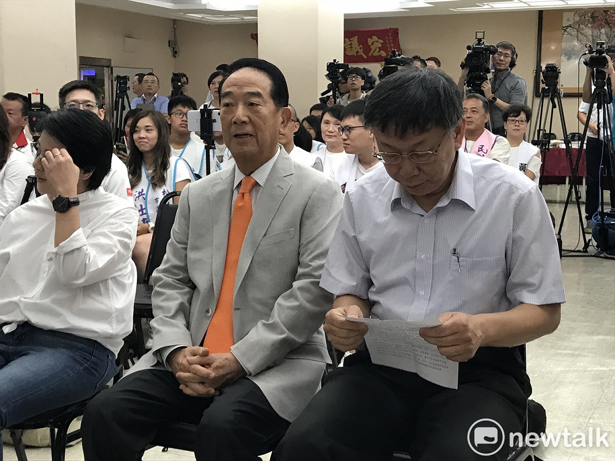剛開始，柯文哲頻低頭猛看資料，只有宋楚瑜一人微笑合影。 圖 : 周煊惠 / 攝