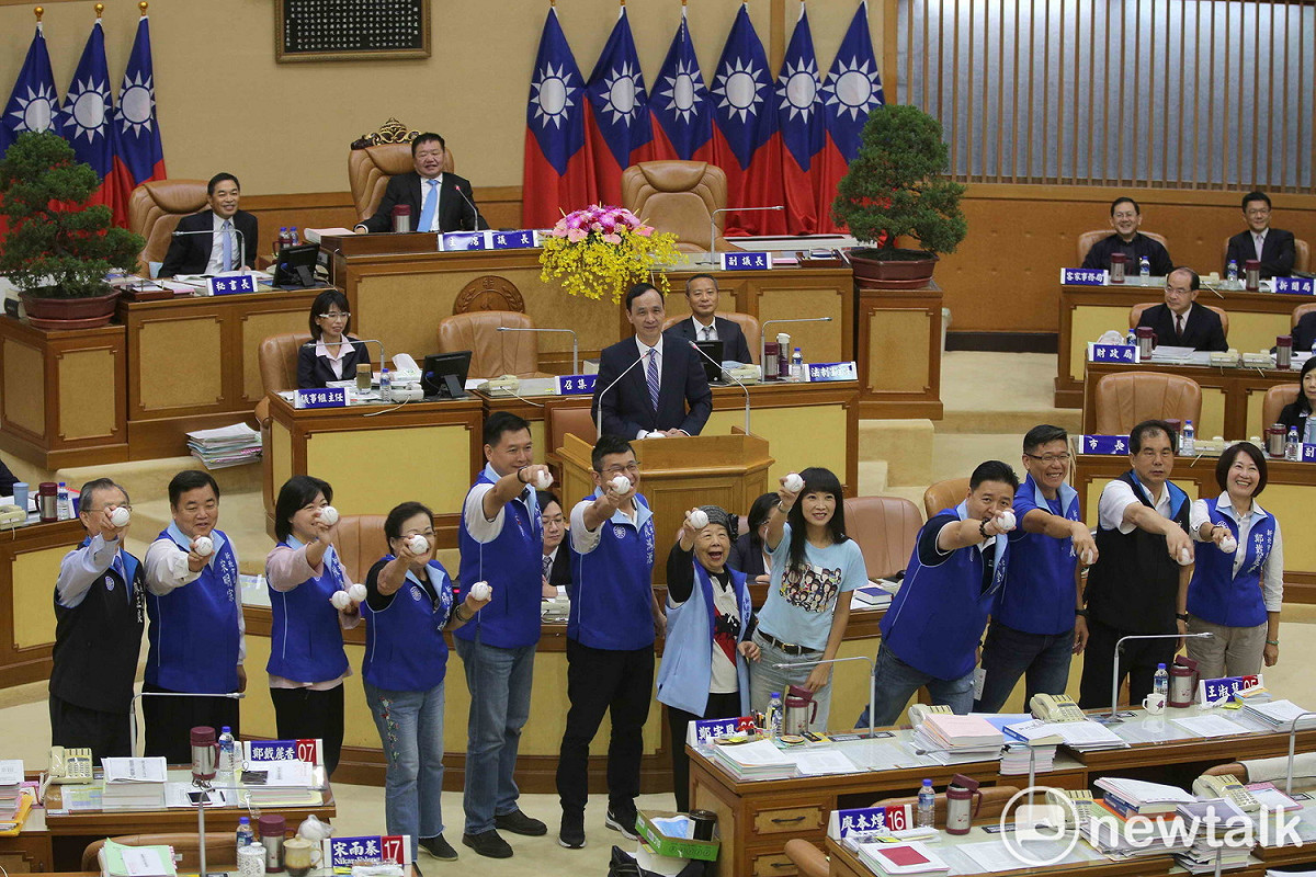 新北市議會國民黨團總質詢，拿棒球給朱立倫逐一簽名後作勢投球，希望年底選舉完封對手，揮出全壘打勝選。
 圖：王峻昌/攝