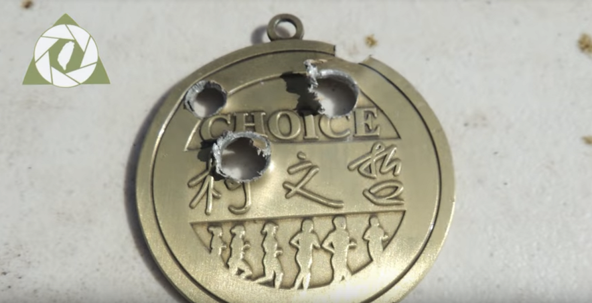 網傳一名男子持槍射擊著有「柯文哲」3字金牌影片。 圖：翻攝Youtube