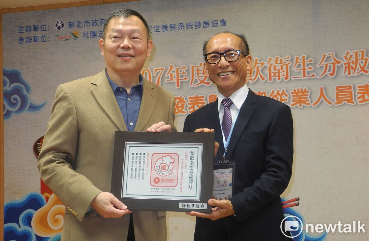 鬍鬚張公司董事長張永昌 (右)接受衛生局長林奇宏頒發證書，並呼籲餐飲業一起提升食安。 圖：王峻昌/攝