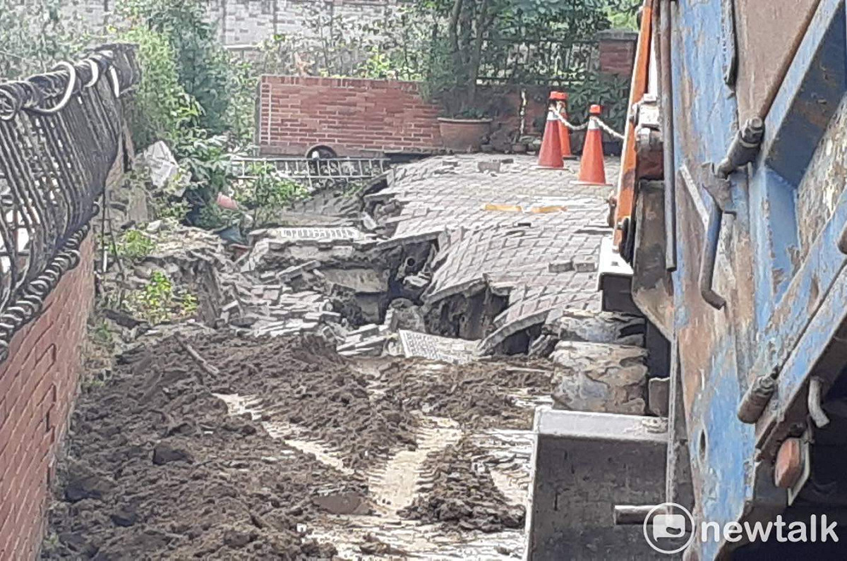 嘉義市新生路北排旁的道路地基掏空下陷，市府工程單位派員搶修。 圖：蔡坤龍/攝