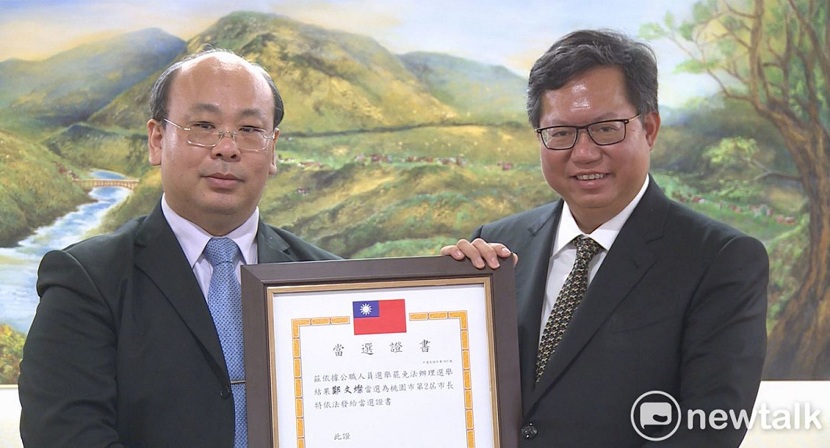 桃園市長鄭文燦自中央選舉委員會代理主委陳朝建手中領取順利連任的桃園市長當選證書。 圖：林昀真／攝