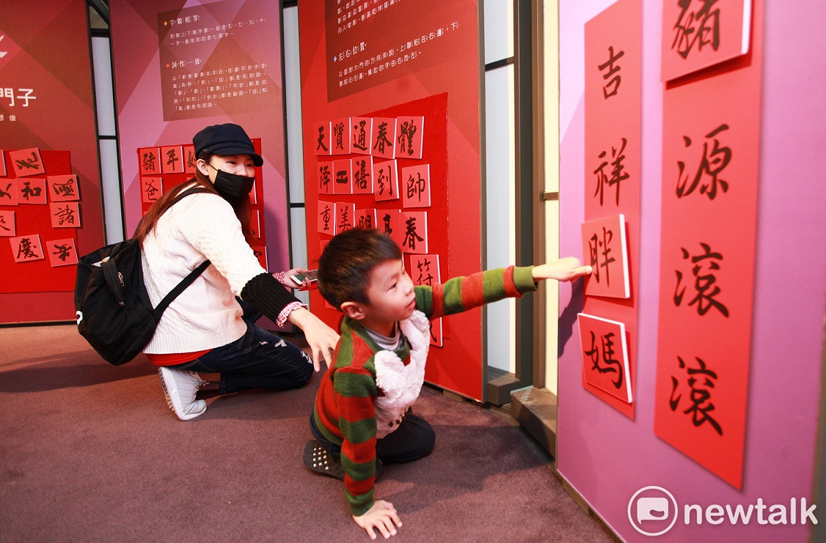 現正在桃園市兒童美術館展出的「春仔串門子-春聯的再想像」春聯展，有讓小朋友可以動手拼貼春聯的互動闖關遊戲。 圖：林昀真／攝