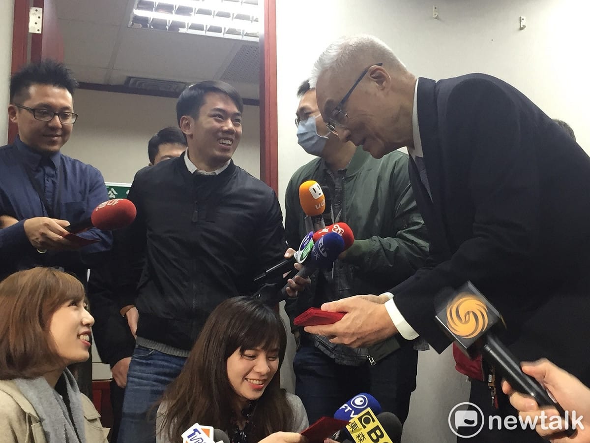 發放完畢後，並主動向媒體拜年並送上福袋，還有記者打趣地提醒「主席，要受訪喔」。 圖：趙婉淳／攝