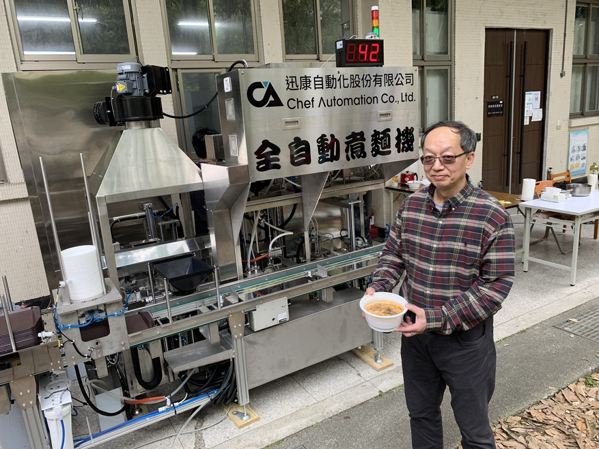 台科大機械系教授林其禹日前開發出全自動煮麵機，取料、煮麵、裝湯、備小菜sop全可交由機械完成，一台機械包辦碗盤供應、煮麵、高湯與小菜，不再需要耗費大量人力，且從點餐到出餐一碗牛肉麵平均只需要一分鐘。 圖／台科大提供