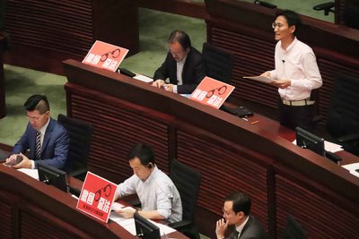 香港立法會3日稍後將會首讀香港逃犯（修訂）條例草案，泛民強烈反對修法；圖為行政長官早上接受議員質詢時，泛民議員在席上擺放「撤回惡法」標語。 圖：中央社