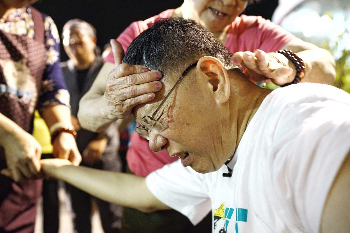 一位78歲的阿嬤幫柯文哲從頭到腳指壓按摩，柯文哲被按到痛處時，臉部頻頻露出痛苦狀。 圖：張良一/攝