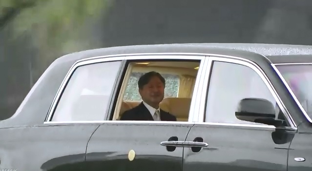 日本德仁天皇22 日一早驅車前往皇居，進行登基大典的準備，在駛入皇居前，他特別開窗向民眾致意。 圖：翻攝自NHK影片