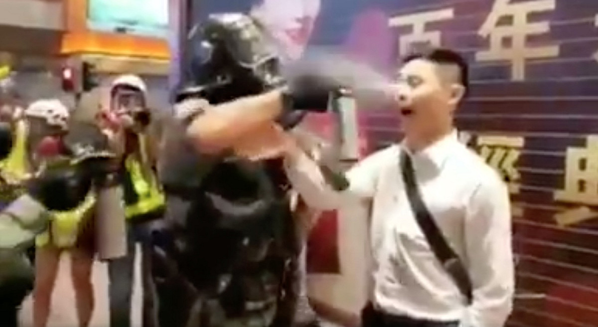 一名白衣男子遭警察盤查，被警方以胡椒噴霧攻擊。 圖：翻攝自社會民主連線臉書
