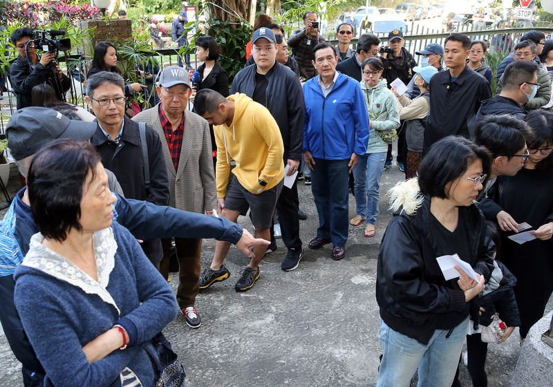 第15任總統副總統及第10屆立法委員選舉11日舉行，許多民眾等著排隊投票。 圖：中央社