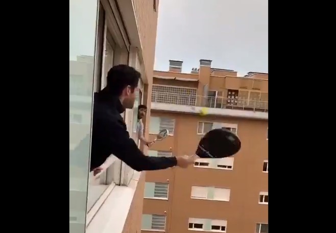 義大利民眾拿出球拍，探出高樓窗戶，和隔壁鄰居十分有默契地打起網球。 圖：翻攝自twitter