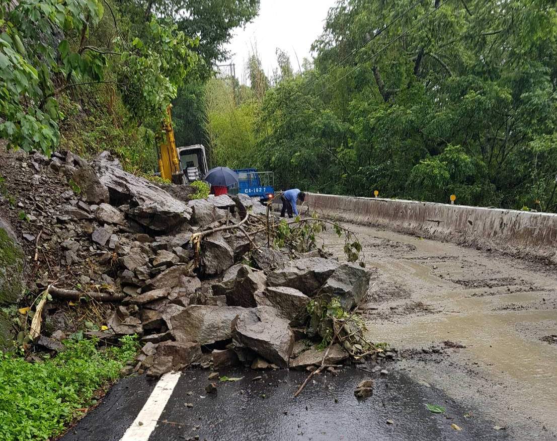 嘉義縣今天凌晨豪雨成災，縣169線明隧道附近落石阻礙交通，工程人員冒雨搶救。 圖：嘉義縣政府/提供