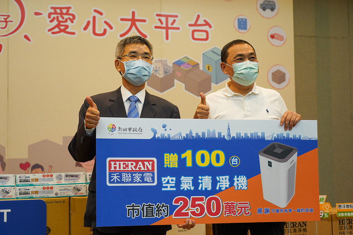 禾聯碩企業董事長蔡金土 (左)捐贈100台空氣清淨機給新北市府，市長侯友宜代表接受。  圖：新北市經發局提供