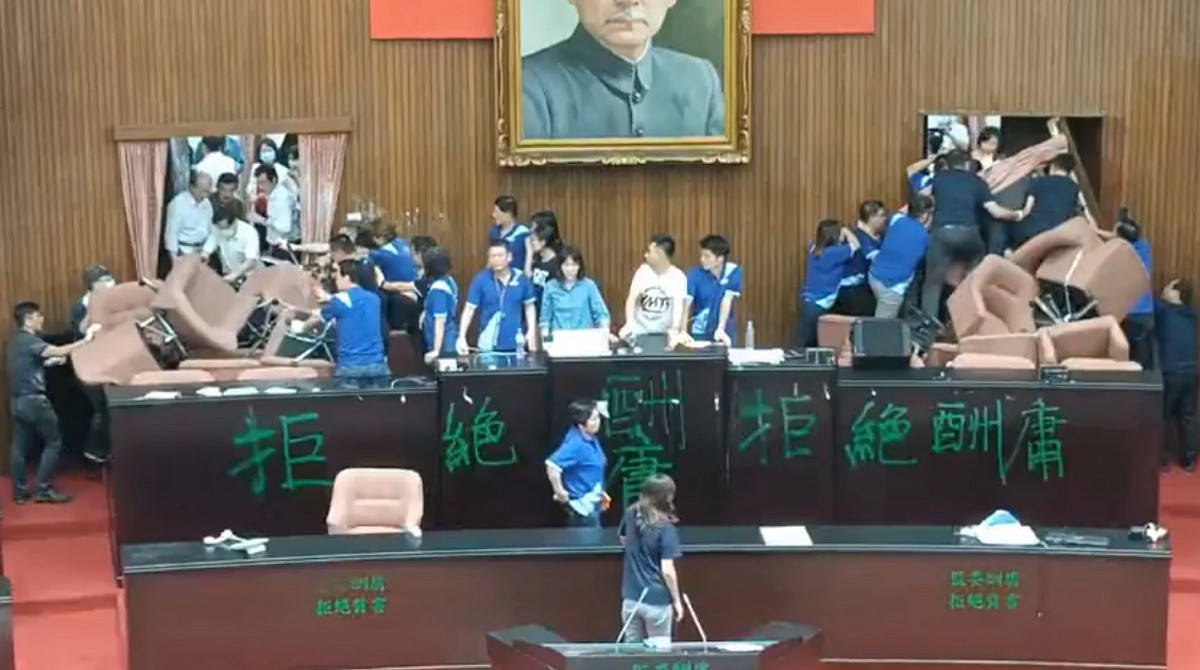 立院臨時會，國民黨團因不滿下一屆的監察院人事案霸佔議場，並用椅子把門堵住。 圖：擷取自國民黨團臉書影片