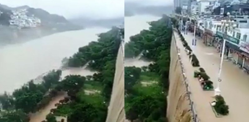 重慶市河濱商店街被積水淹沒，黃澄澄的泥水從峭壁傾瀉而下猶如瀑布。 圖：翻攝微博