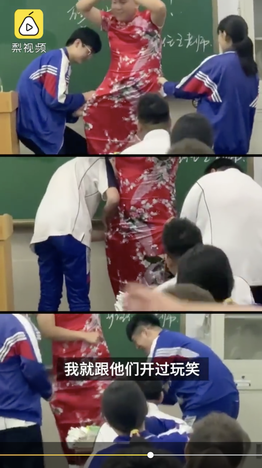 為了能降低考生壓力，遼寧丹東某校男班主任，穿上了大紅的旗袍走進教室，邀請孩子們一人在旗袍上剪一刀，意味著剪越高分數越高。 圖：擷取自梨視頻影片