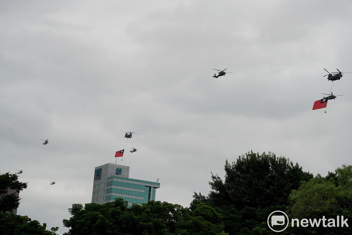 兩架CH-47SD直升機懸掛兩幅巨型國旗和7架UH-60M直升機在上午7:01首先通過總統府前上空。 圖：張良一/攝