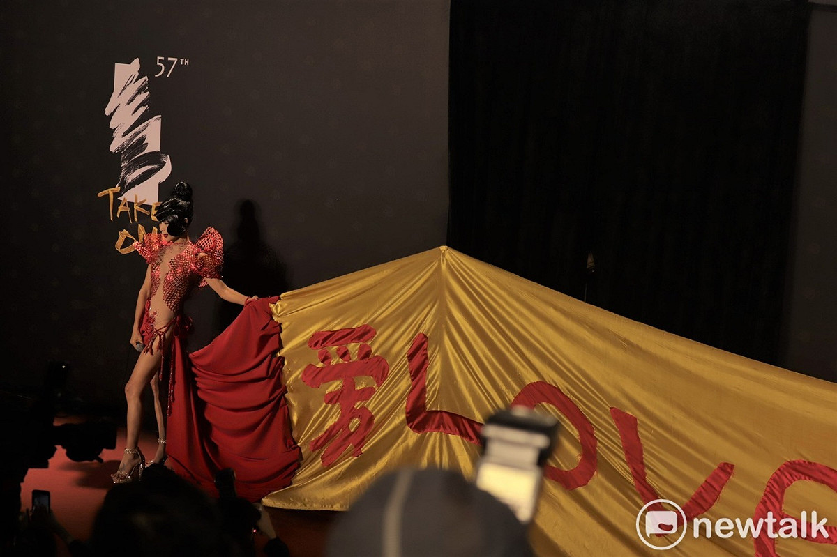 白靈的禮服拖著長尾，寫著愛與和平。 圖：汪靖軒/攝